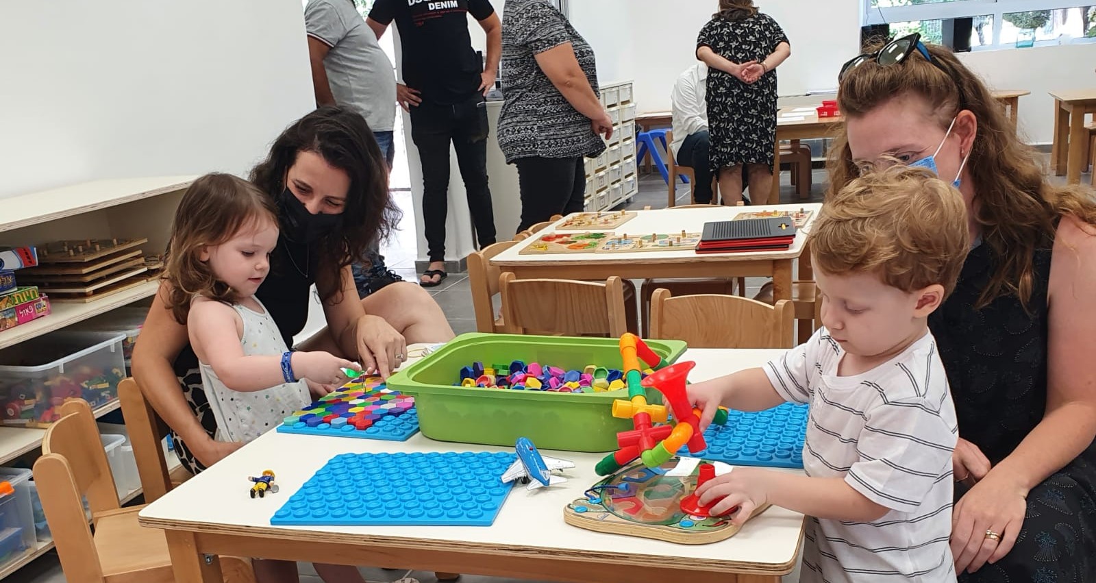 ילדים משחקים לצד הורים