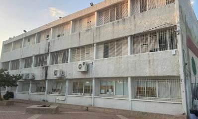 בית הספר היסודי גולן במערב רמת השרון. מבנה של שלוש קומות עם חלונות גדולים ותריסים. בקומה התחתונה סורגים בחלונות. רחבה מרוצפת לפני הבניין ושני עציצים בנויים מבטון ובאחד מהם עץ.