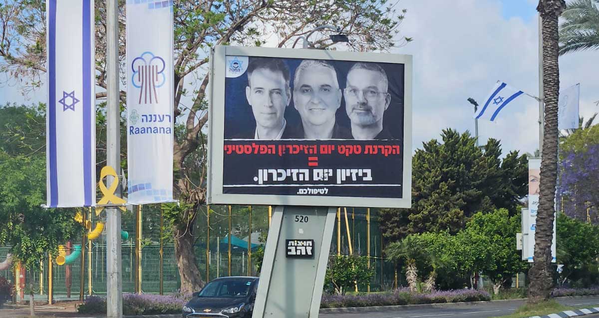 שילוט חוצות על שטח הפרדה בין נתיבים ברעננה. לצידו דגל ישראל ודגל עיריית רעננה. בשלט כתוב: הקרנת טקס יום הזיכרון הפסלטיני = ביזיום יום הזיכרון. לטפולכם. בשלט תמונת ראש העיר וסגניו