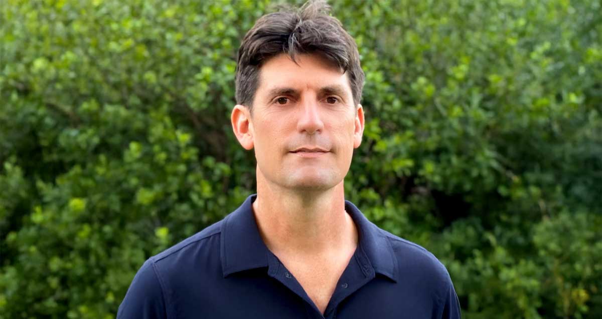 ד"ר ארד אדר. תמונה של פלג גוף עליון על רקע של צמחייה. חומה וצמחייה.