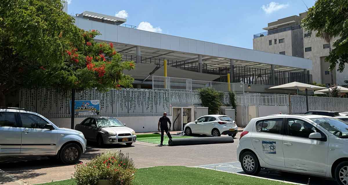 אשכול גני ילדים ברחוב צבי מנדלבלט הרצליה. המתחם מוקף בגדרות מתכת. מקומות חנייה לרכב בחזית הבניין.