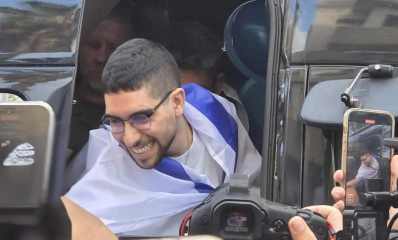 אביתר דוד חוזר הביתה יוצא מהרכב כשהוא עטוף בדגל ישראל, צילום, עיריית כפר סבא