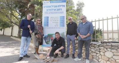 משמאל - אייל פביאן, יריב פישר ואלכס גולדשטיין, ליד שלט של העירייה עם כיתוב: סלילת שביל אופניים רחוב ארלוזורוב מקטע הרחובות בן גוריון - בית"ר.