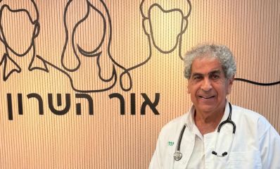 פרופסור עובדי דגן עומד עם חלוק לבן על רקע קיר המרפאה, צילום: כללית