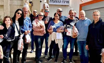 סיירת חלוקת חלות רמת השרון. צילום קבוצתי של הנשים והגברים עם חלות ביד.