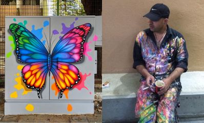 שלומי ישראל יושב עם בגדים שחורים מלאים צבע ותמונה של ציור פרפר צבעוני על ארון תקשורת, צילום פרטי