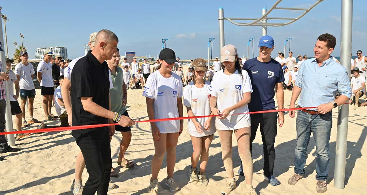 ראש העיר הרצליה יריב פישר, סגן ראש העיר עופר לוי, יובל עילם ונערה גוזרת את הסרט במתחם כושר קרבי החדש בחוף אכדיה בהרצליה
